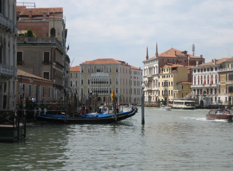 a water way with several gondolas moving on the side