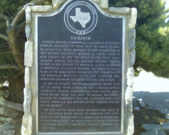 the plaque is set in front of the tree