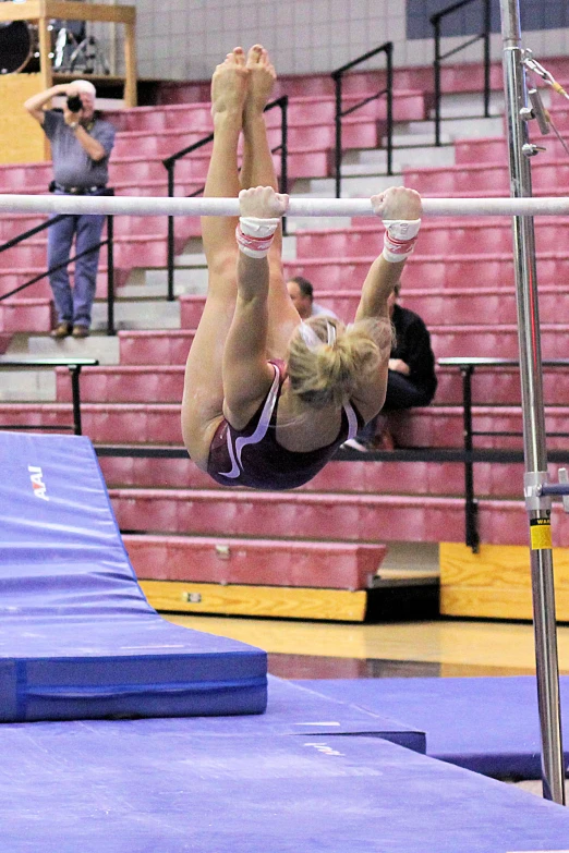 a woman on a pole performing a stunt on a city track