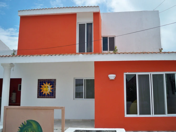 a brightly colored house with tile design and a painting