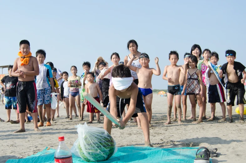 a group of s watching as one boy throws soing