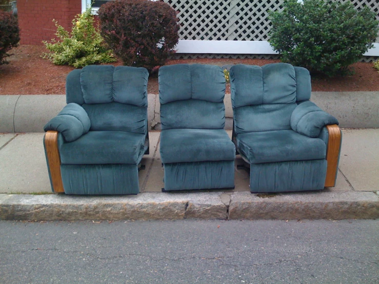 two chairs and a recliner are on the sidewalk