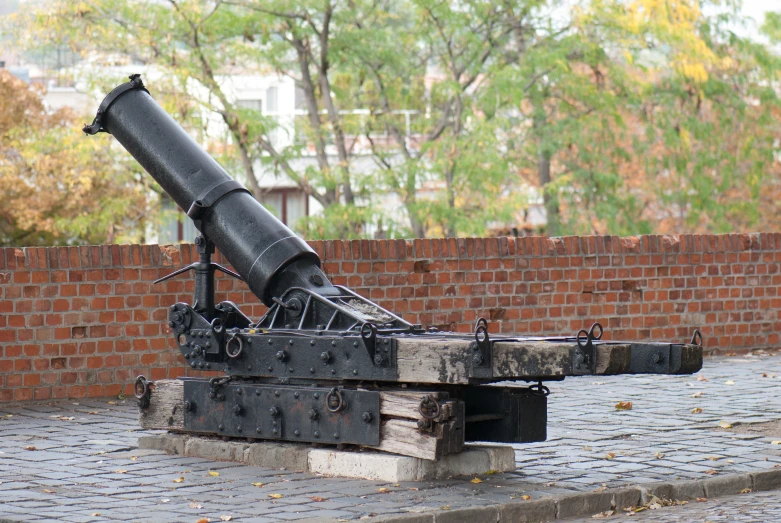 a black cannon with two missiles attached on it