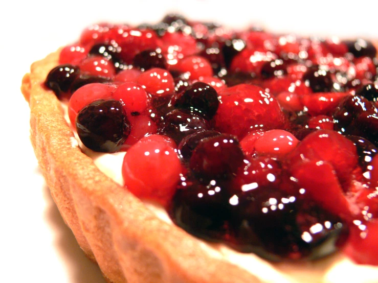 an image of a pie with cherries and syrup on top