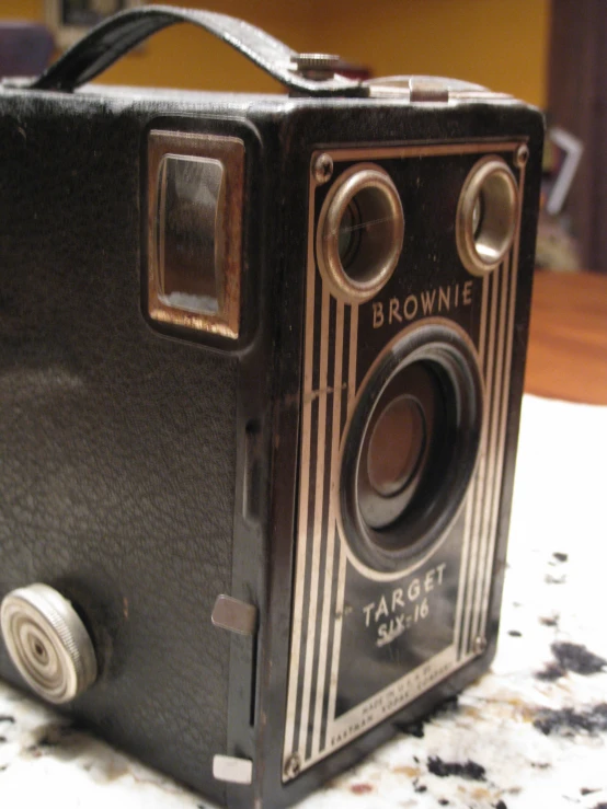 an old camera sits on a table