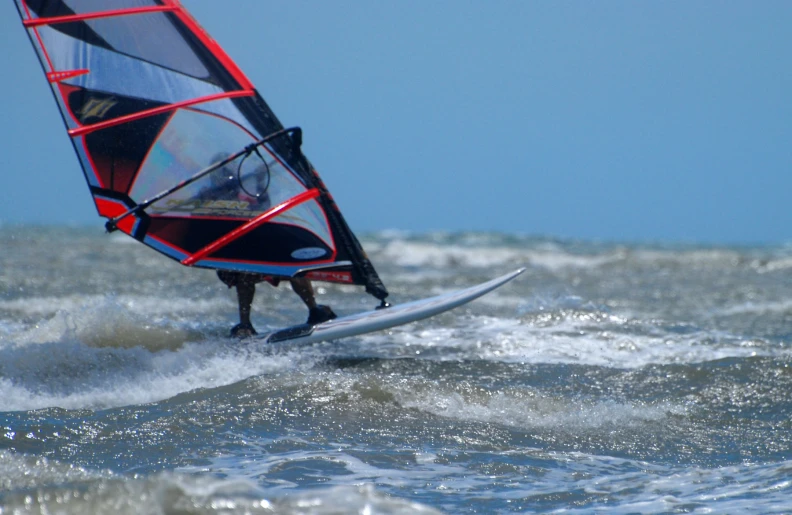 a windsurfer in the ocean riding the waves