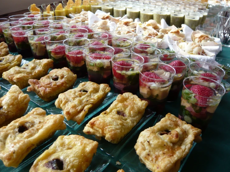 many trays are lined up and have different foods in them