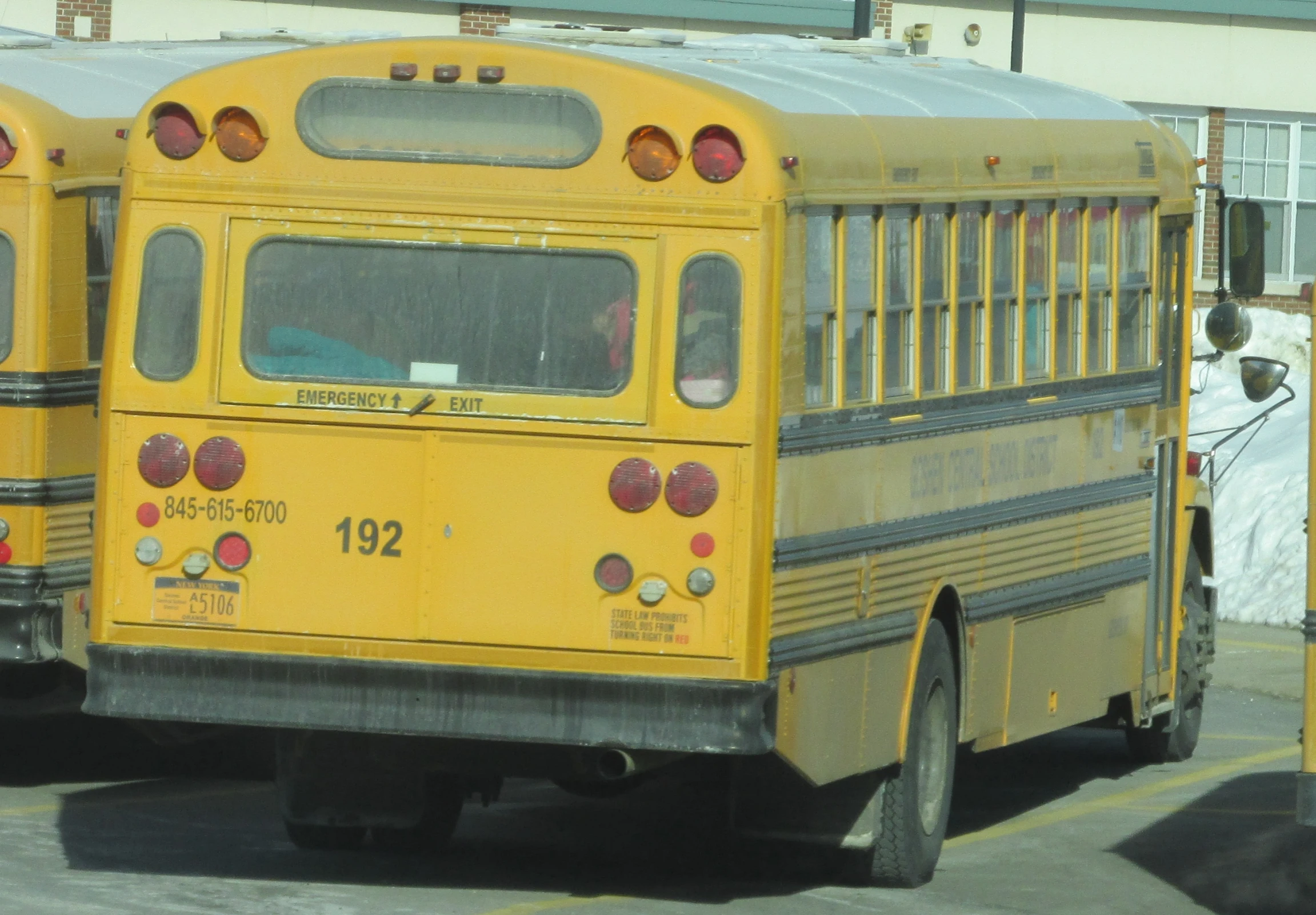 three school buses parked in a parking lot