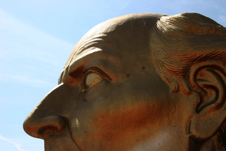 a closeup po of the face of a buddha statue