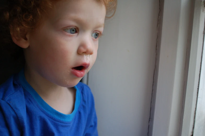 a close up of a child with food in his mouth