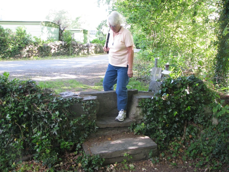 a woman standing on top of cement steps