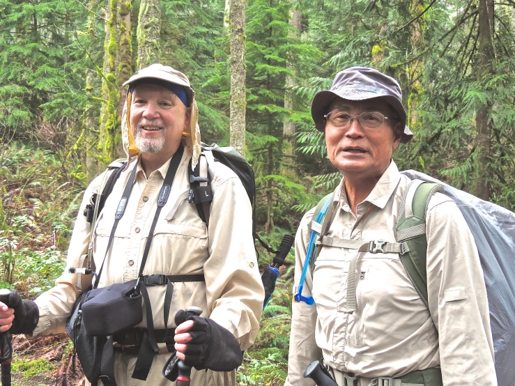 two people in hiking gear in the forest