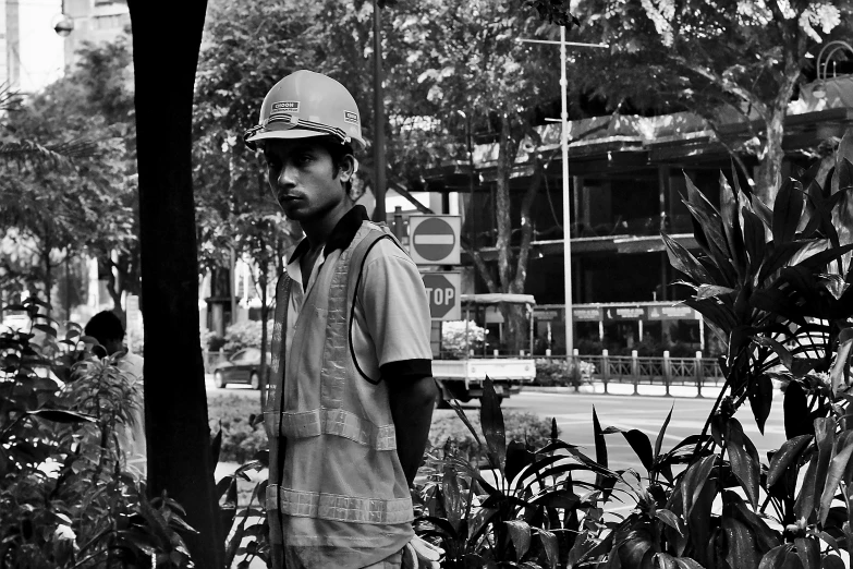 a young man in safety helmet looking away from the camera