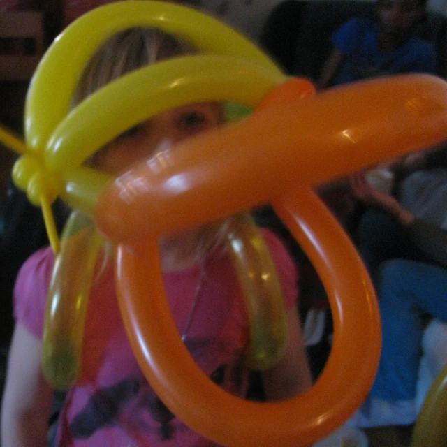 a girl has some balloons on her head