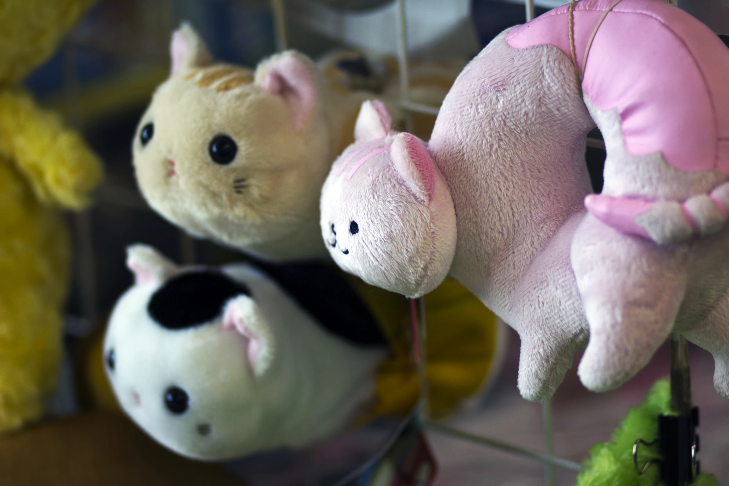 several stuffed animals on the line of dolls