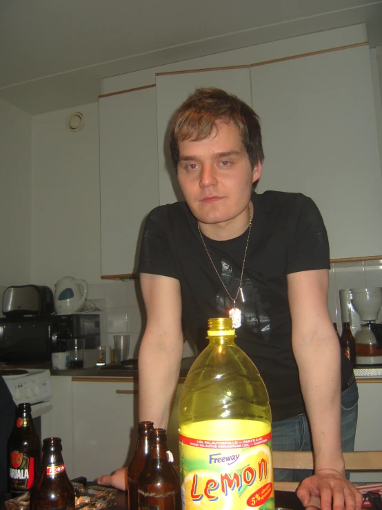 a man sits at the table with several bottles