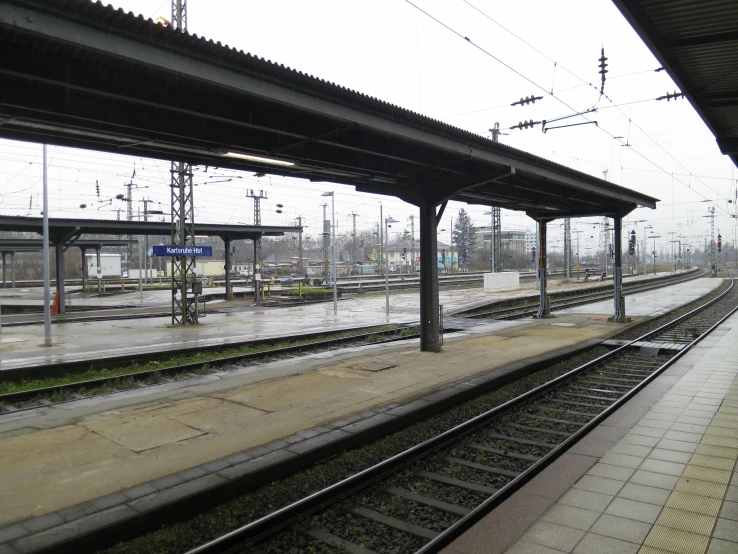 empty train tracks in the middle of a railway station