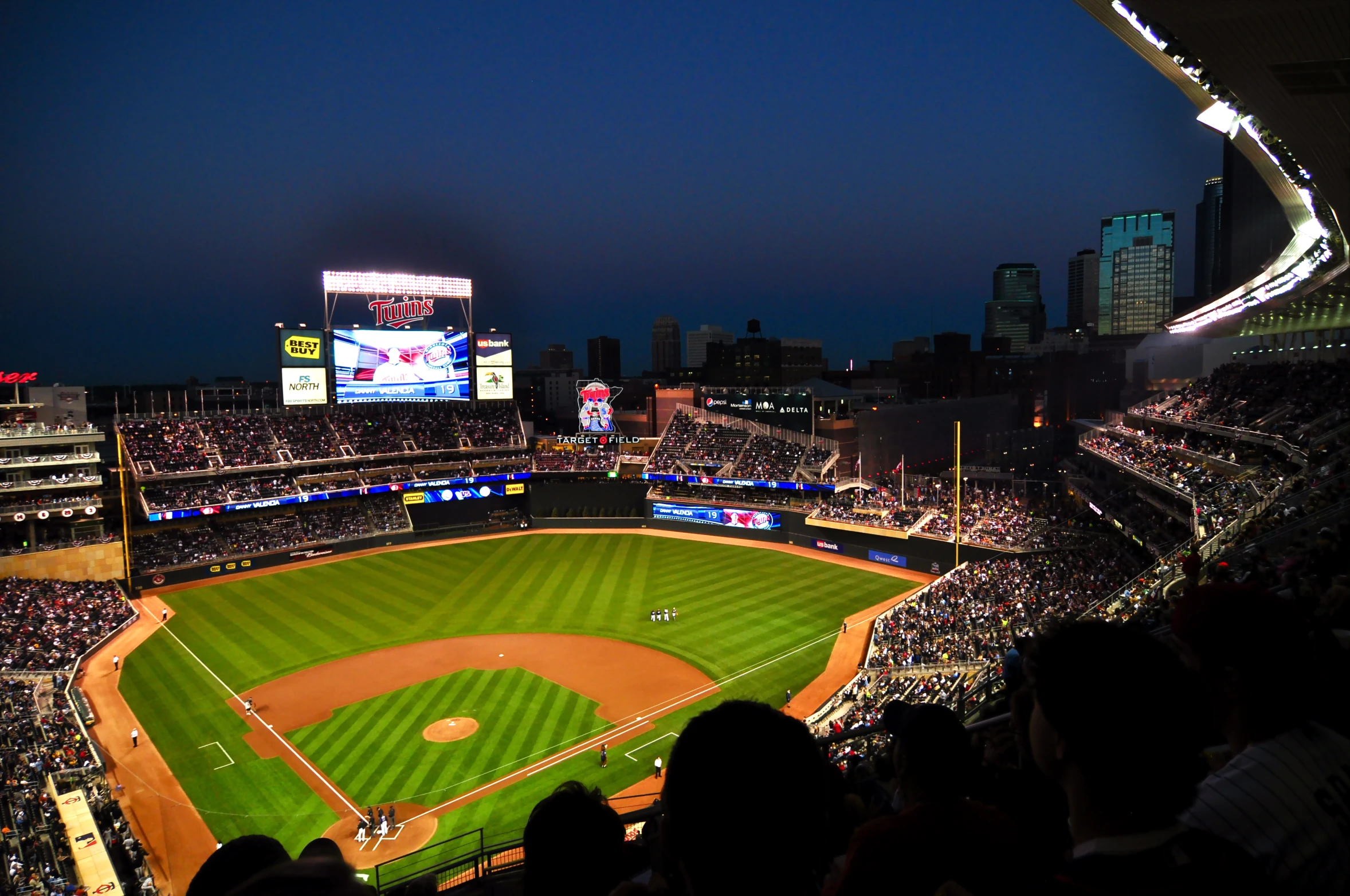 a crowd in the stands watching a baseball game