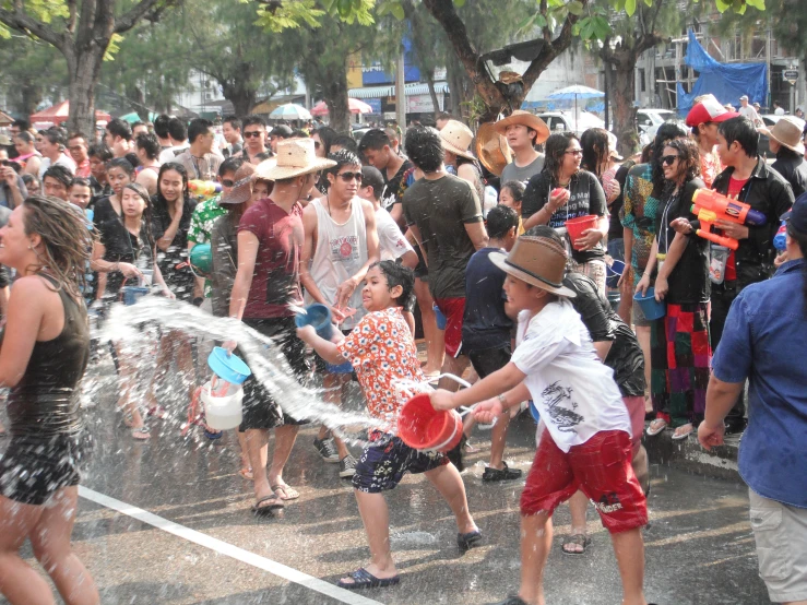 young children playing with a sprinkle of water