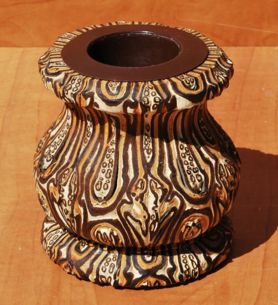 a decorative ceramic vase sitting on a wooden table