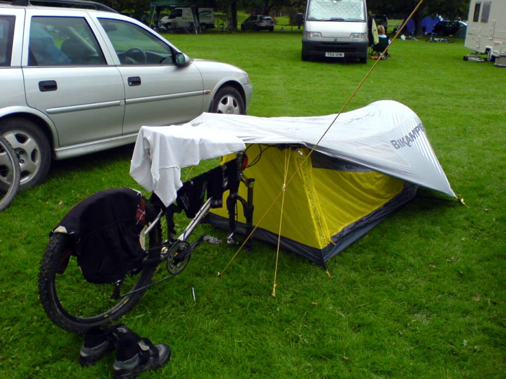 an umbrella and bicycle tent in the grass