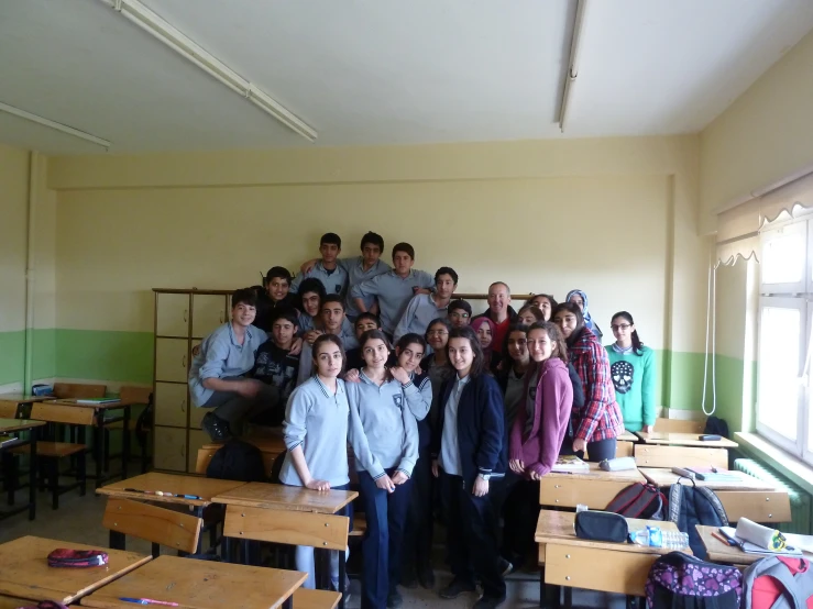 a group of people standing next to each other in a classroom