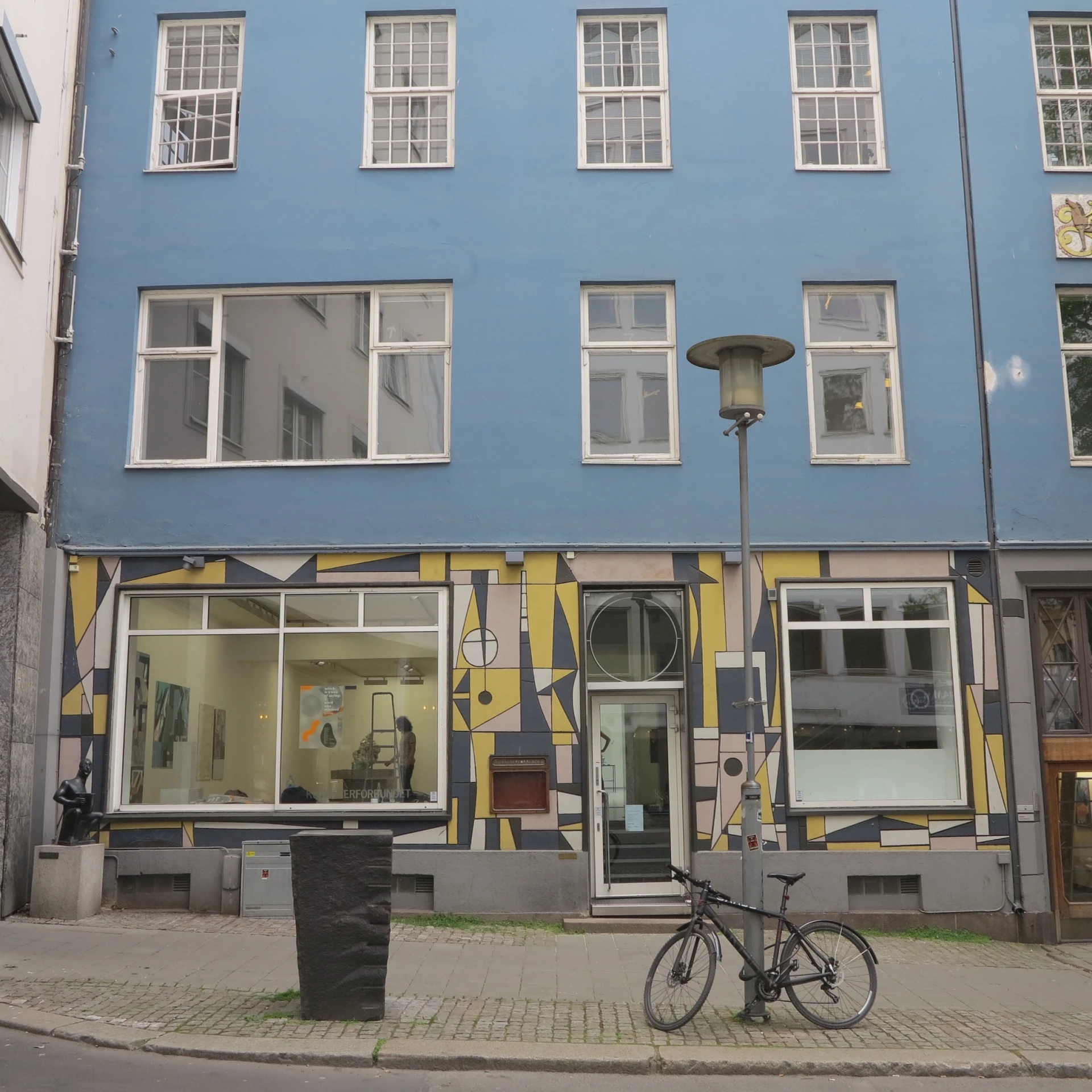 a bike parked in front of a blue building