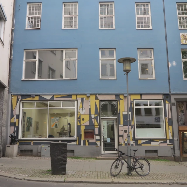 a bike parked in front of a blue building