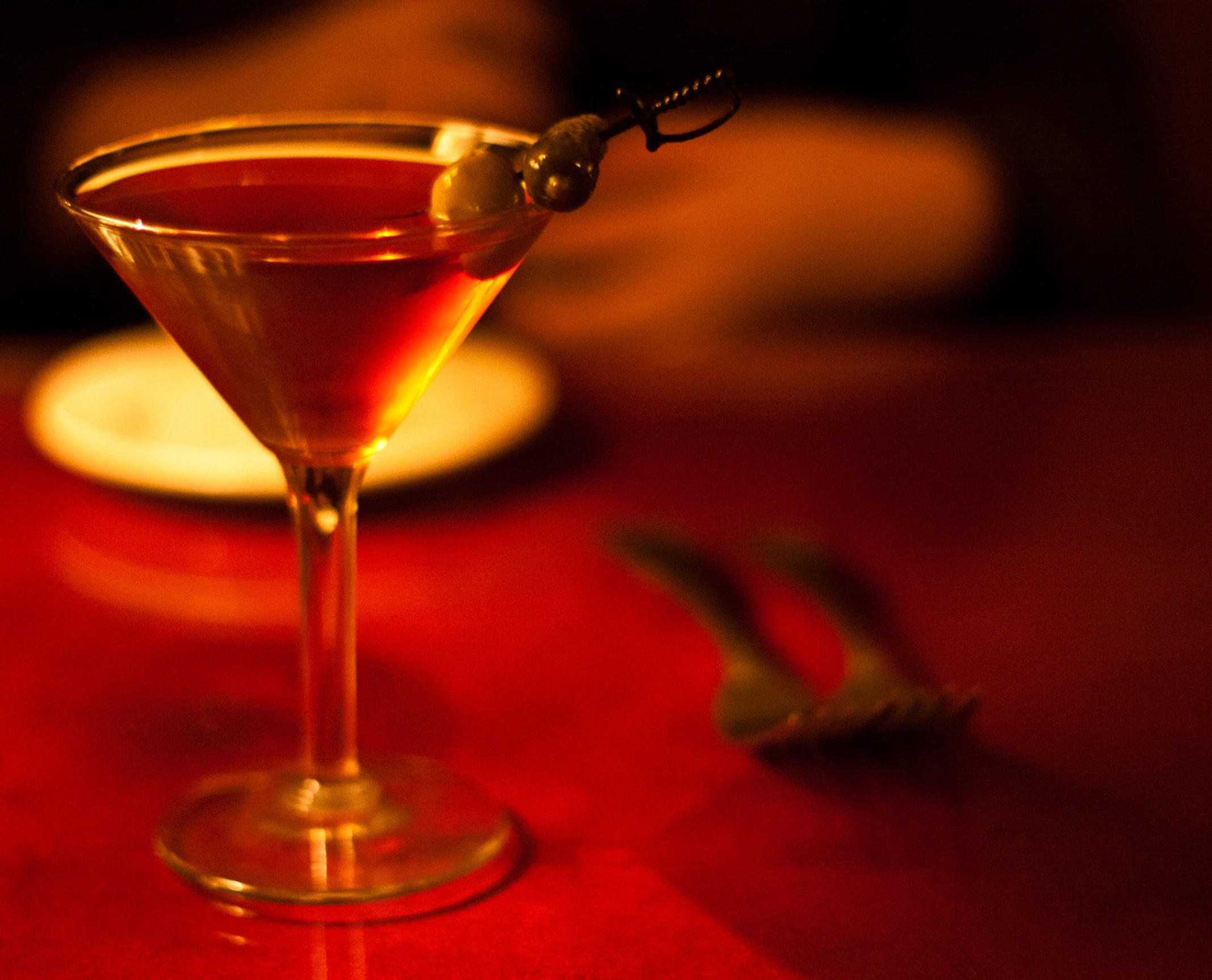 a dark and spook looking drink sits on a table