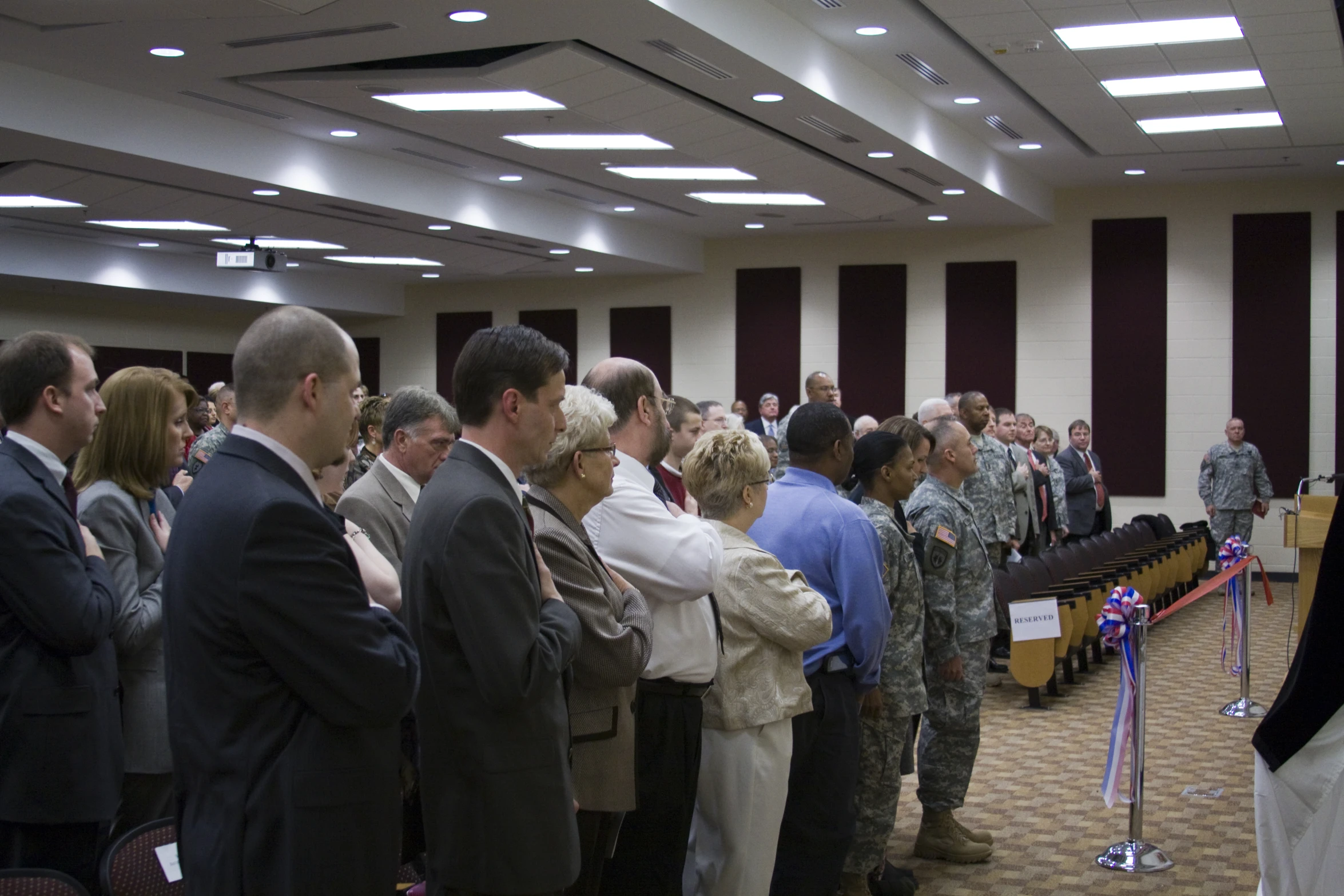 people standing in the room with two microphones