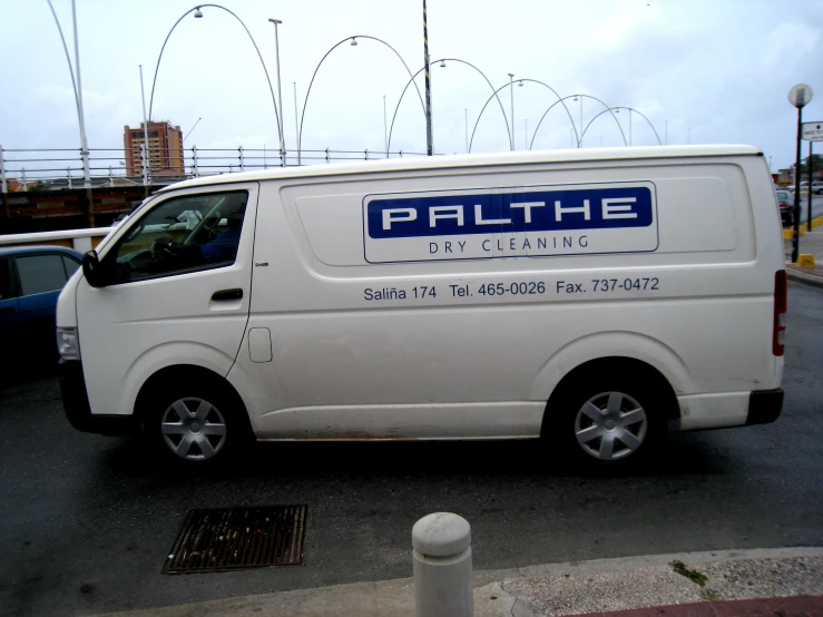 a white van is parked by a building