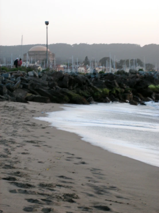 a black and white po of people walking along a shoreline line