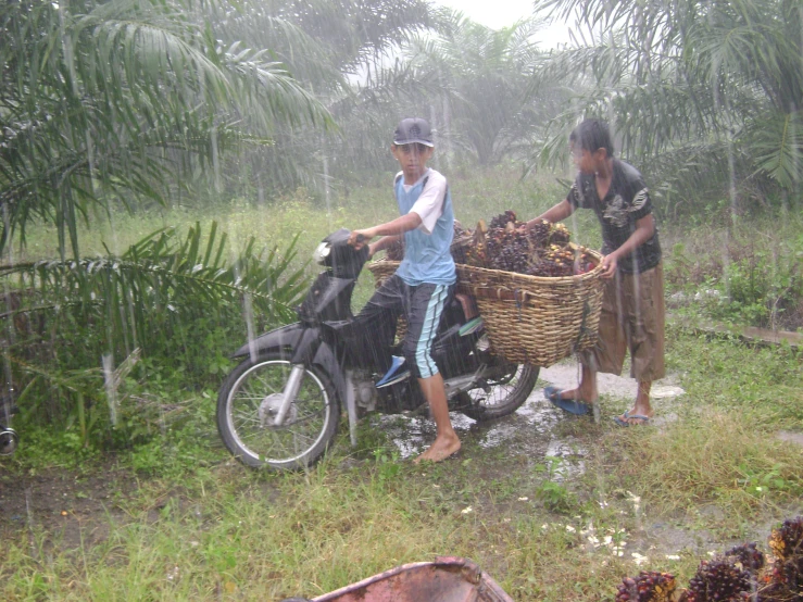 two men riding a motorcycle holding baskets filled with items