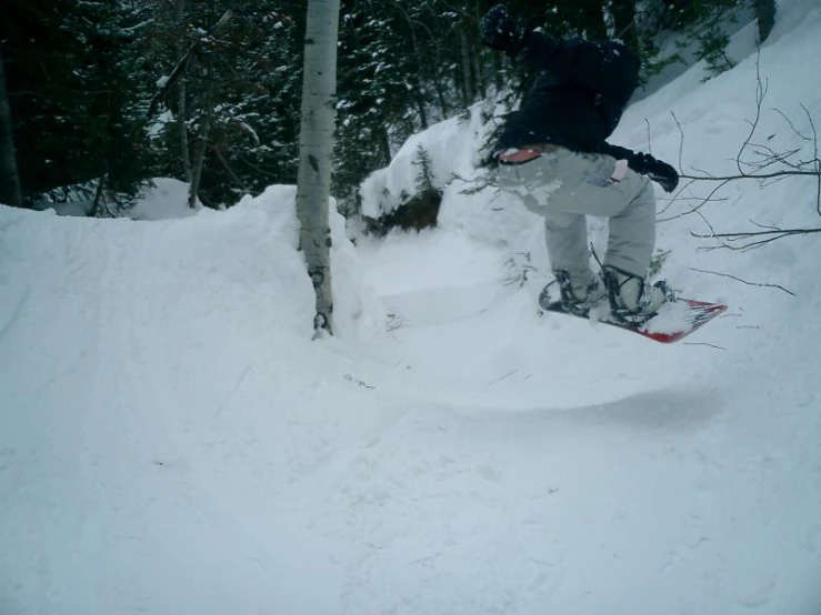 the man on skis is doing tricks in the snow