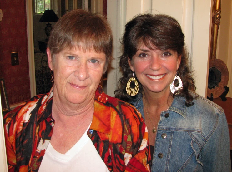 an older woman standing next to a younger lady