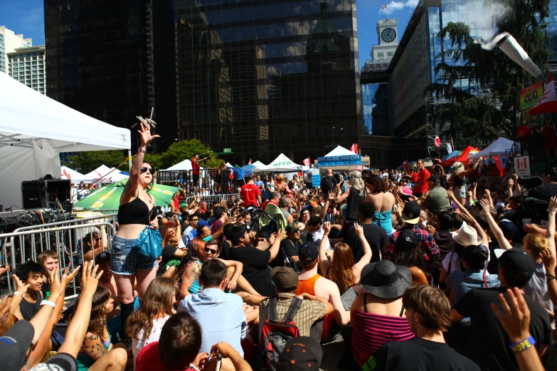 a crowd of people are in a city square