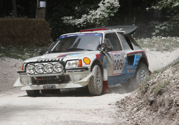a rally car driving on a dirt road