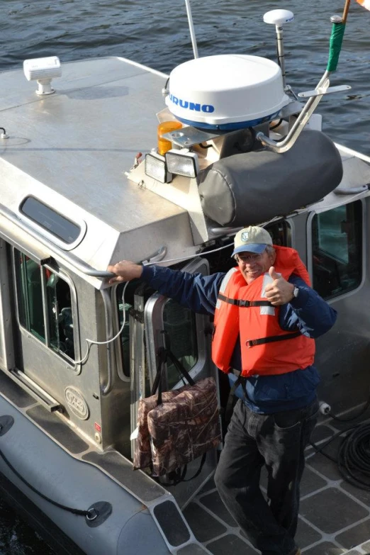 man on boat taking order from the driver's door