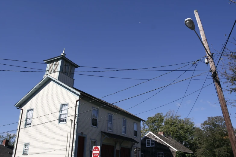 a po taken from below of a building, with telephone poles in the foreground