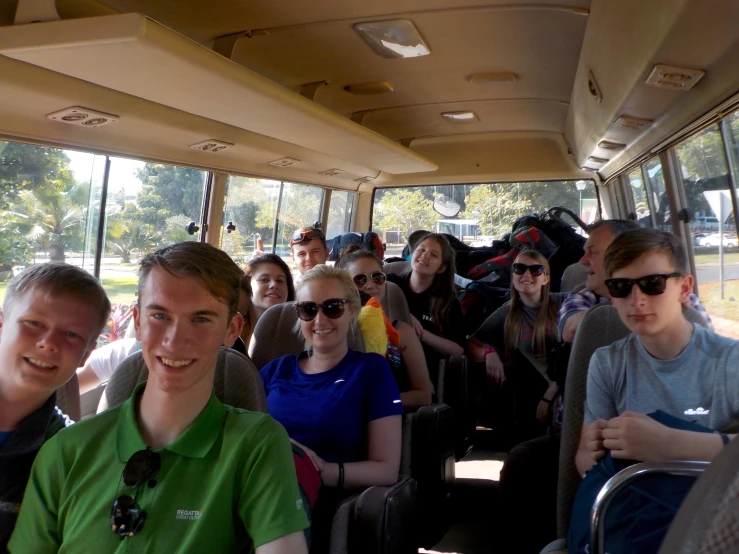 a group of people on a bus with sunglasses