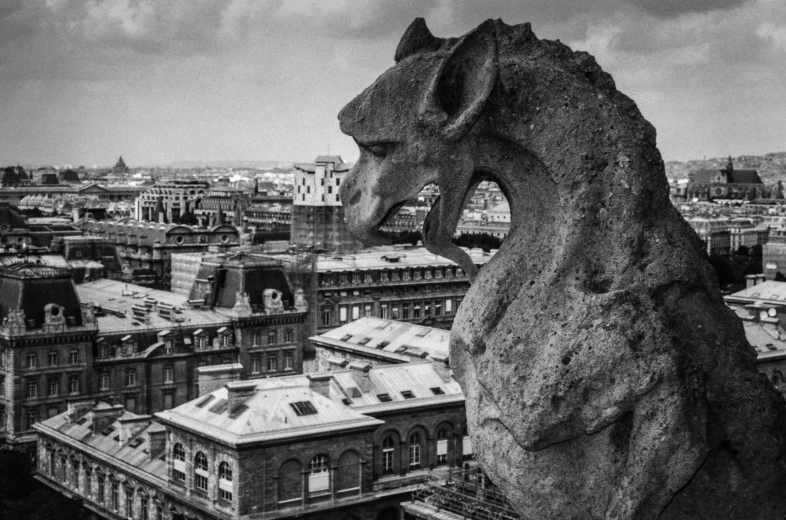 a statue of a dragon above a city