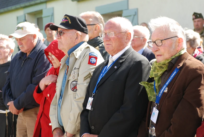 men and women stand with medal holders at a ceremony