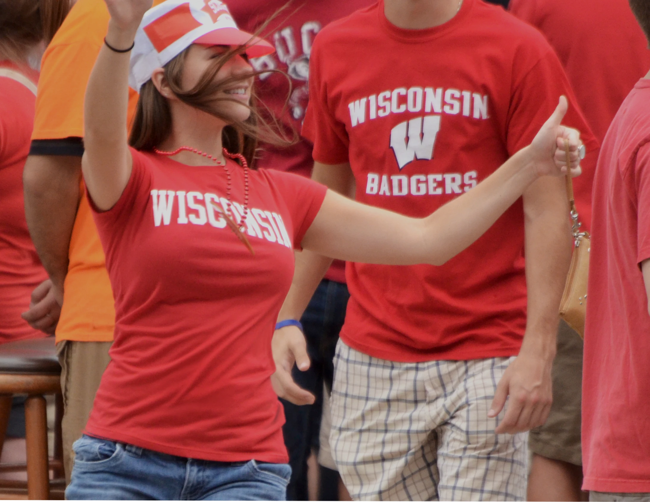 a woman with two thumbs up in front of a group