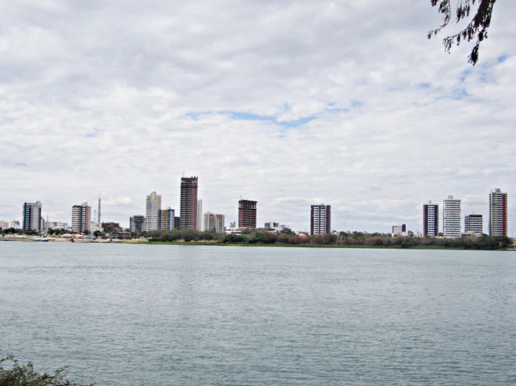 a city skyline on the lake with tall buildings