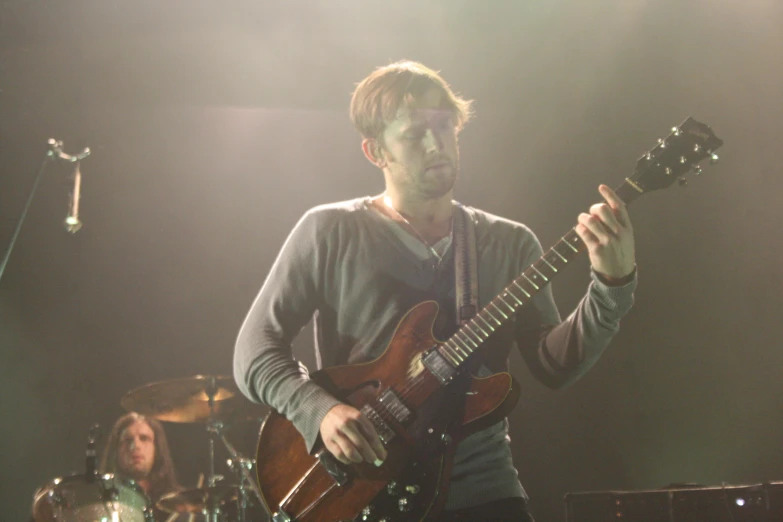 man holding his guitar during a live concert