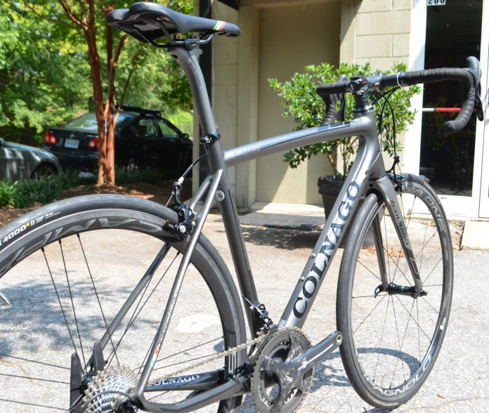 a bike parked on a paved path in front of a building