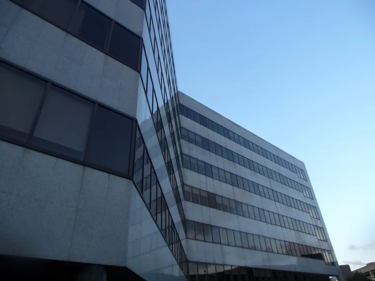 the side of an office building with some windows on each of it