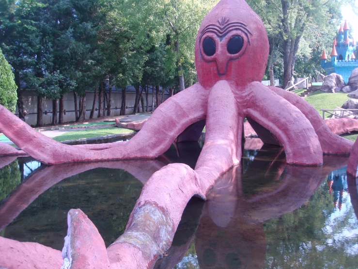 a giant pink object sitting in a pool