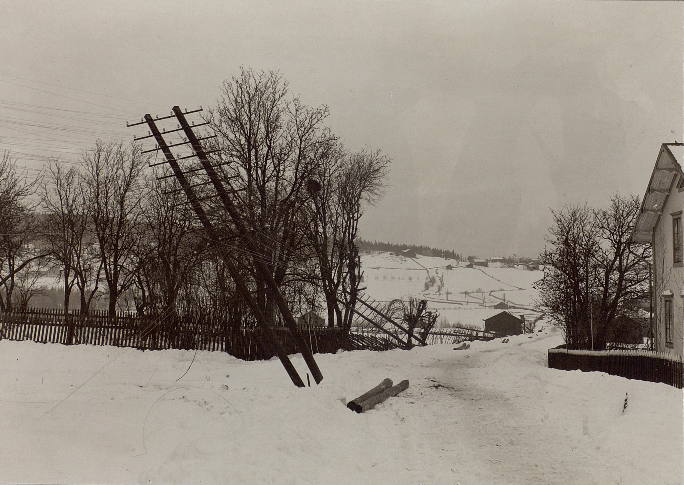 an old po of houses and a fence on a snowy slope