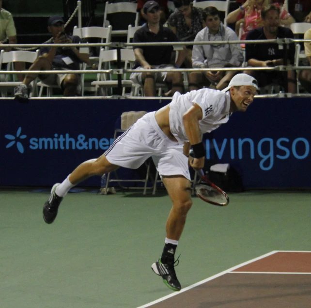 a male tennis player in a white shirt and shorts